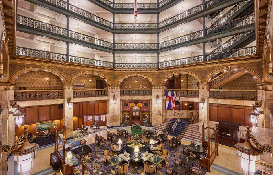 A wide view of the Brown Palace Hotel and Spa's main lobby, featuring an open-court style.