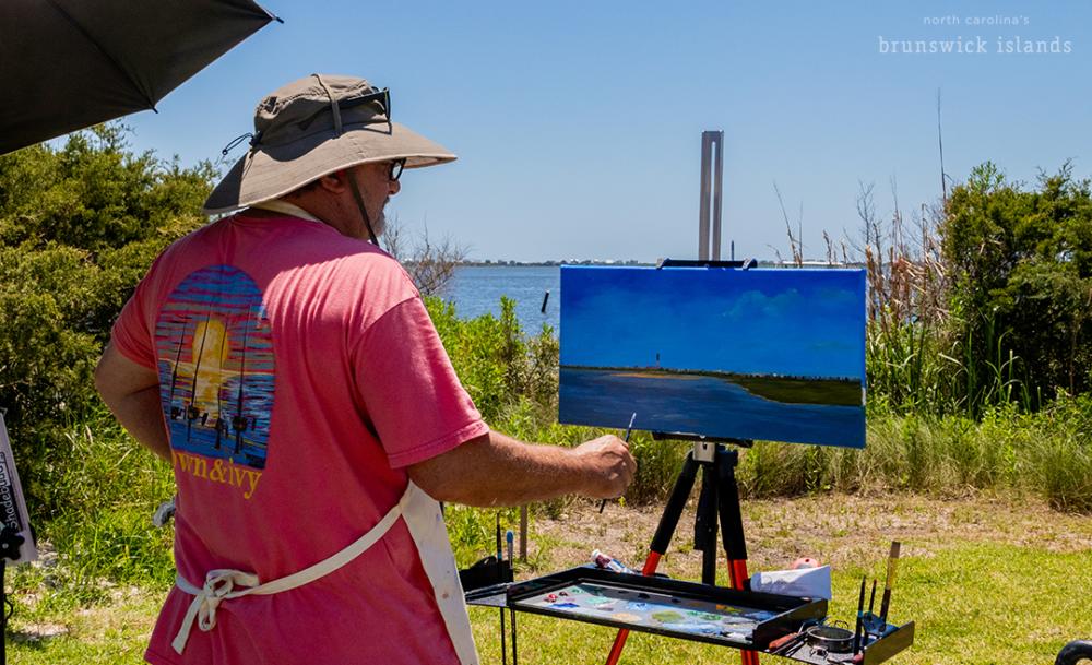 man painting a view outside