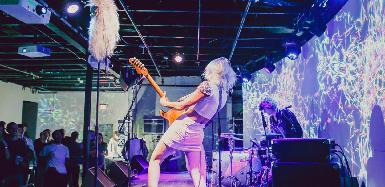Woman on stage with guitar
