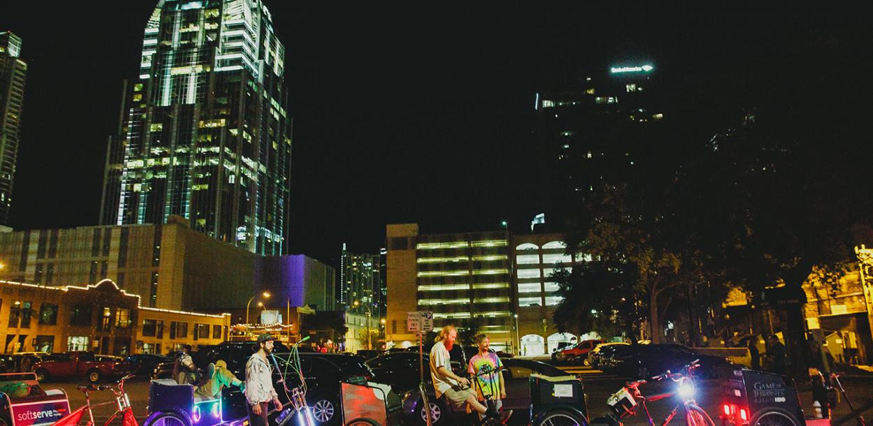 Pedi Cabs wait in downtown Austin at night