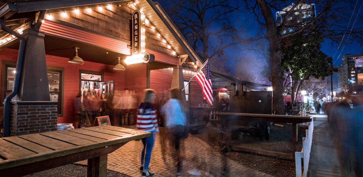 exterior of Bangers Sausage House and Beer Garden at night on rainey street in austin texas