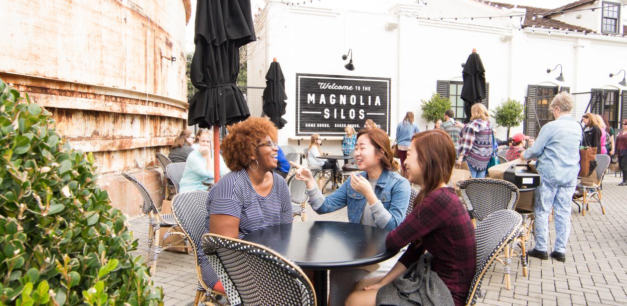Women sitting together around table on Magnolia Silos patio in Waco Texas