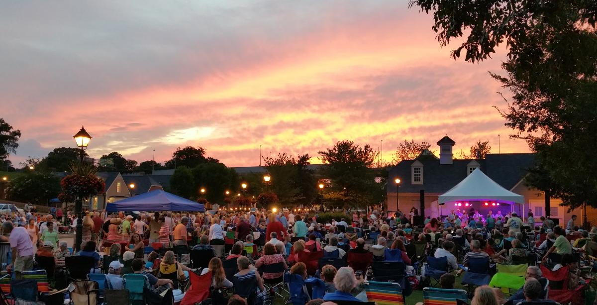 Large Crowd listening to music as the sun sets
