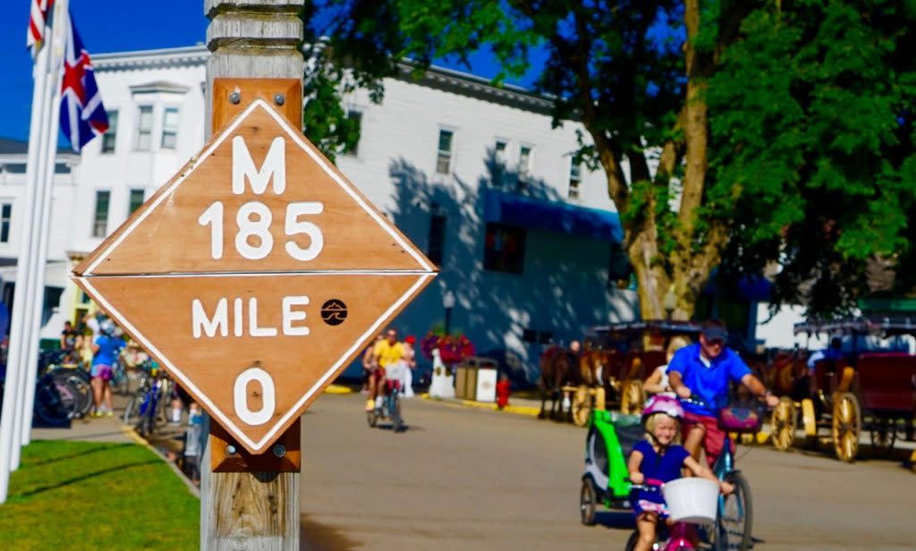 Mackinac Island things to do include riding a bike 8.2 miles around the outer rim of Mackinac Island on car-free M-185.