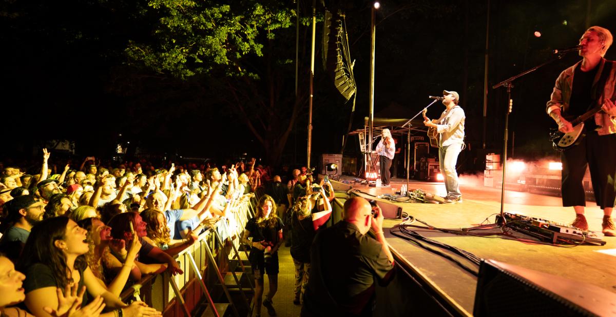Band playing on stage at night for a live audience.