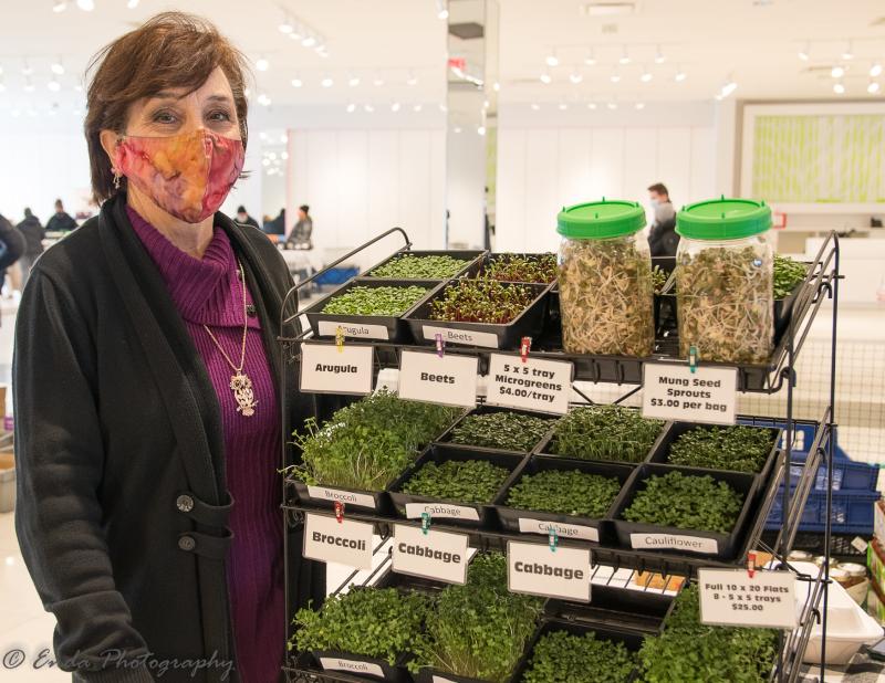 Woman showcases her crop at the Maple Grove Farmers Market