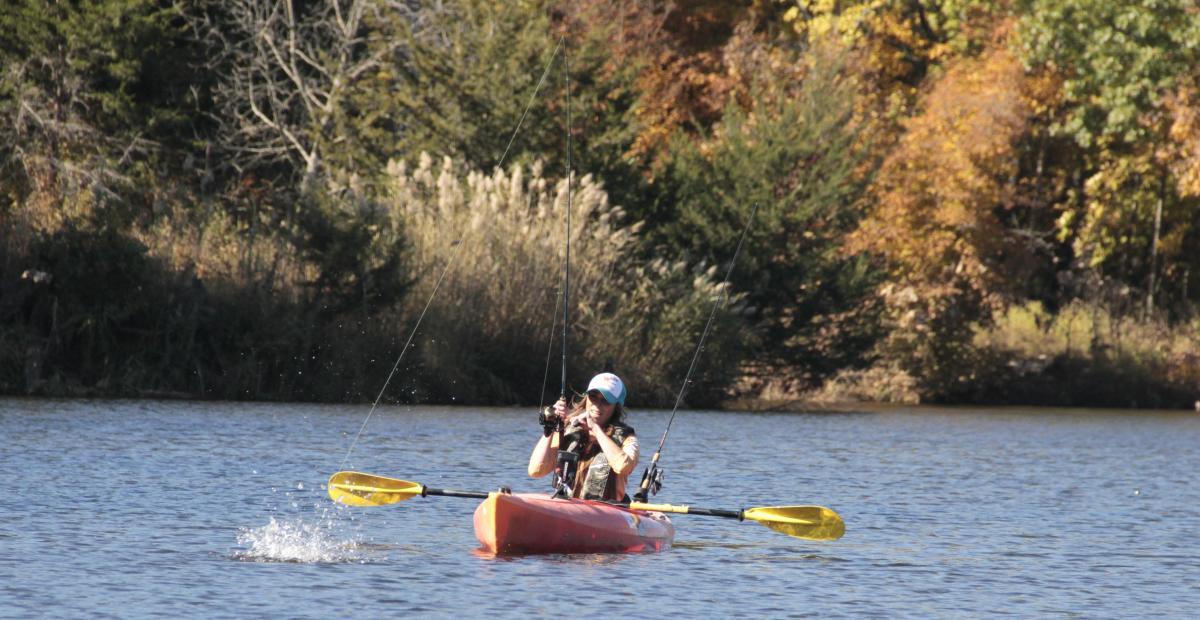 A woman fishing on her kayak