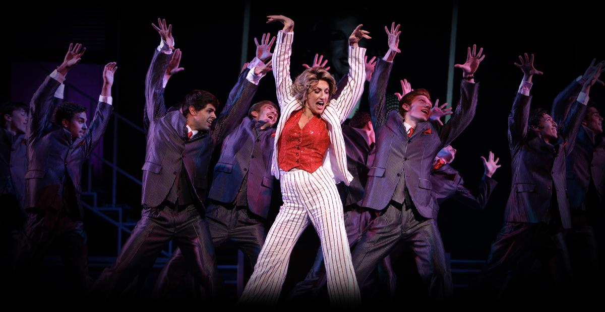 The cast of "9 to 5" performs on stage