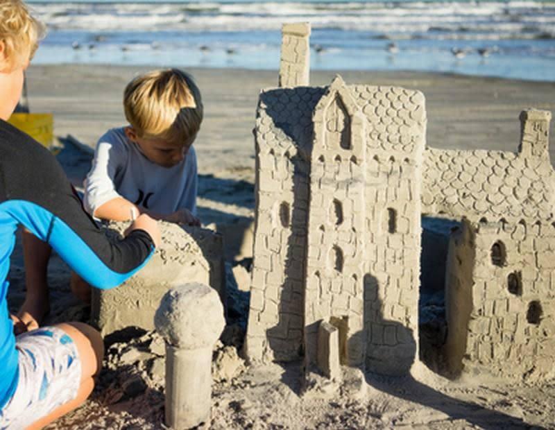 Beach Rules - Kids building sandcastle on beach