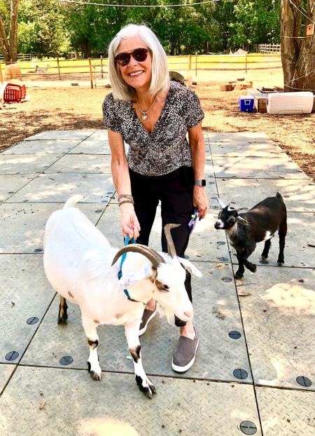 Lois Villemaire and a goat at Wild Kid Acres