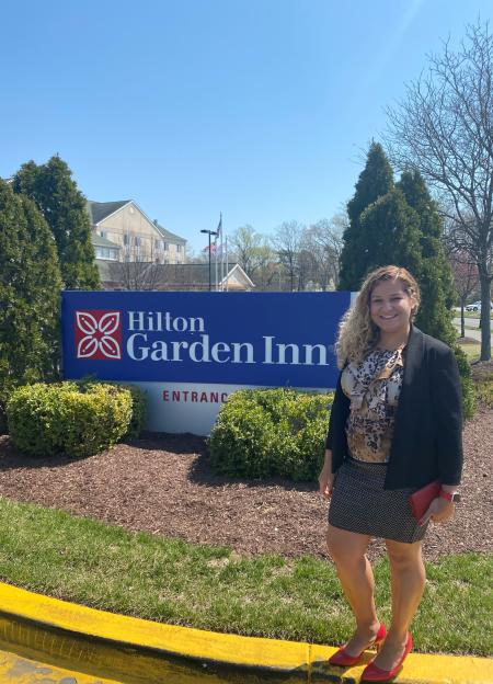 Wilka Nascimento stands in front of the Hilton Garden Inn on Harry S. Truman parkway