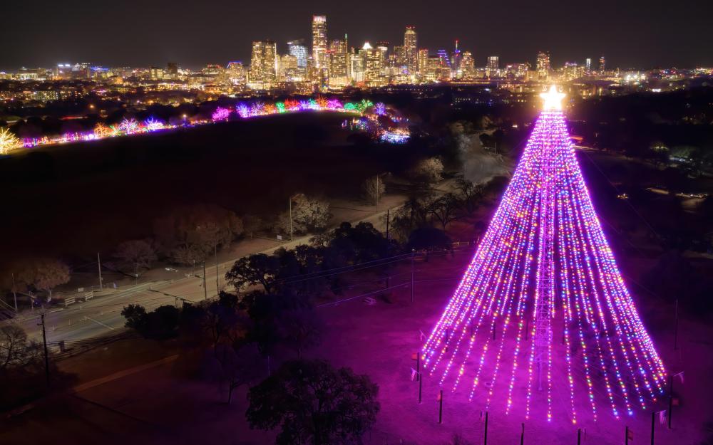 Image of Trail of Lights illuminated at night with the Downtown Austin skyline in the background.