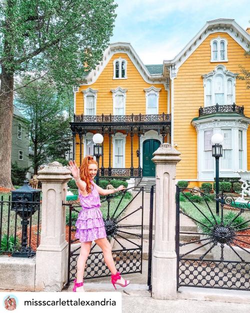 Woman in front of mansion row in downtown New Albany