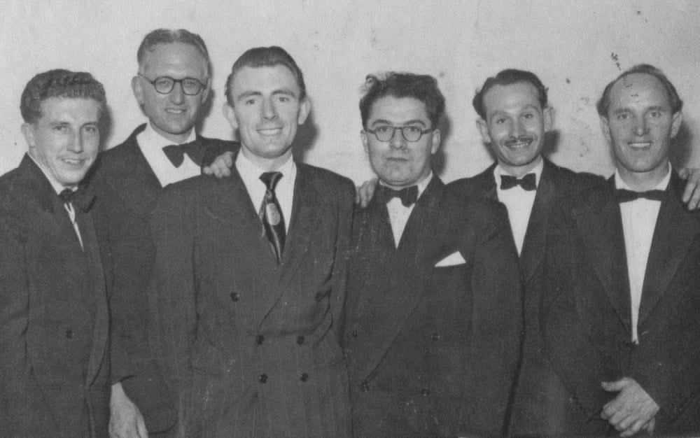 A black and white photo of six men in suits and ties.