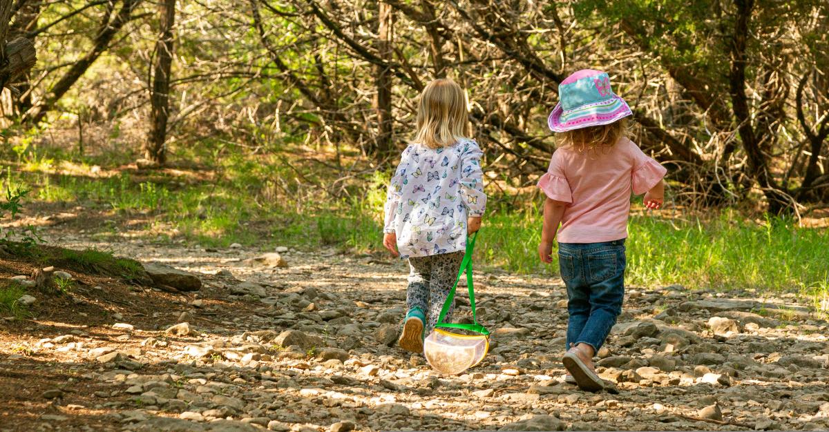 Two little girls walking down trails