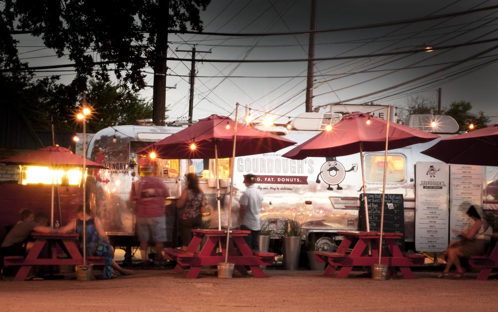 Gourdoughs donuts South First Street airstream food trailer at twilight with tables and twinkle lights