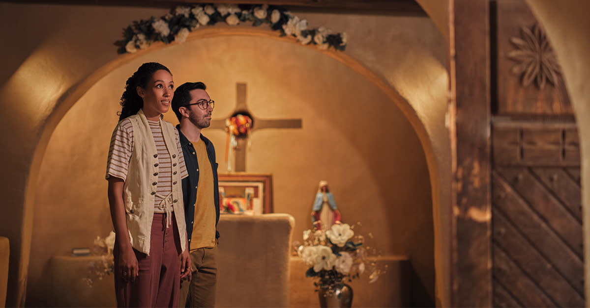 Two people stand in a chapel in Old Town.
