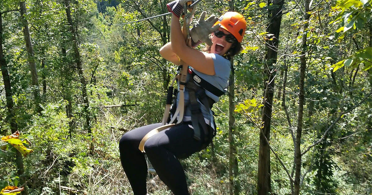 Person zip lining at Boone Creek Outdoors in Kentucky.