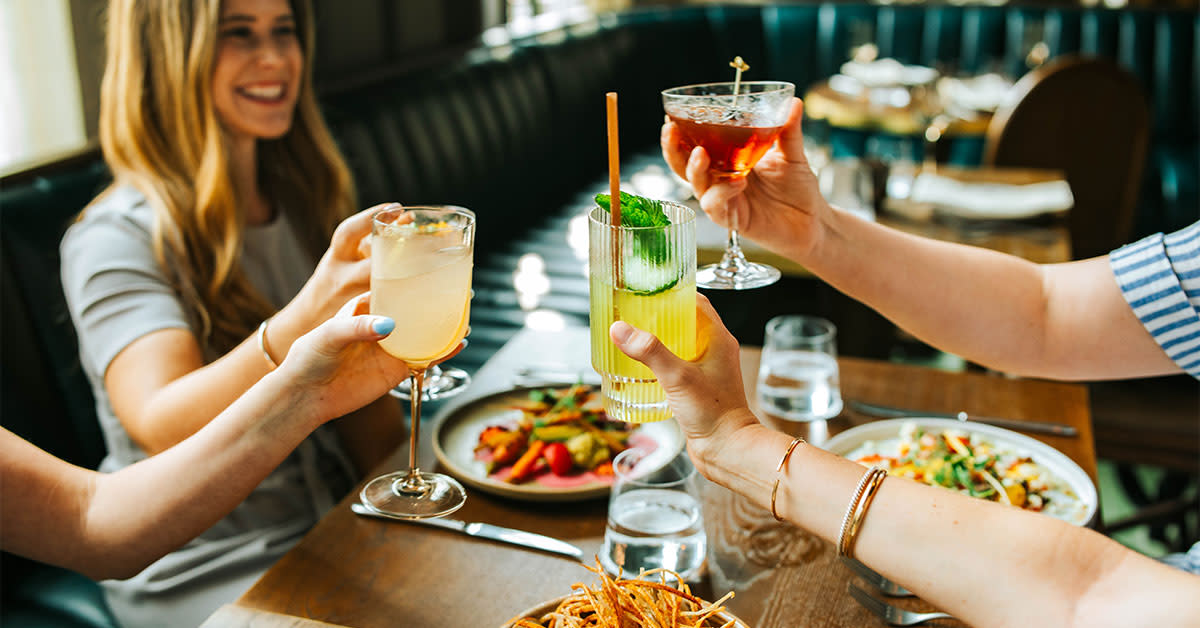 People toasting their drinks at Granddam restaurant in Lexington, Kentucky
