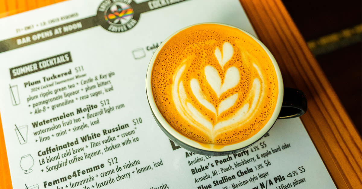 Cup of coffee on top of a menu at Lussi Brown Coffee Bar Lexington Kentucky.