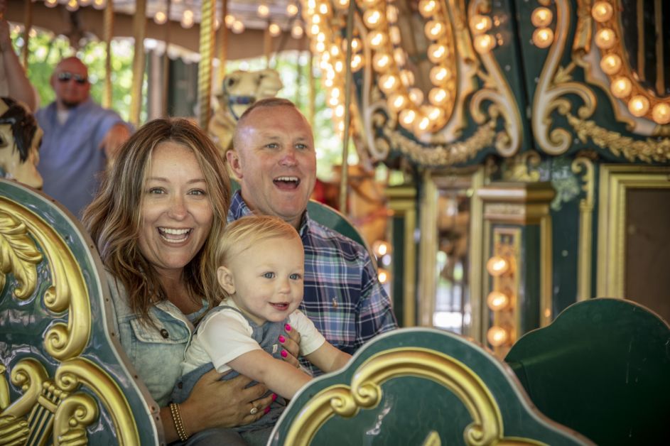Family on carousel at Dan Nicholas Park