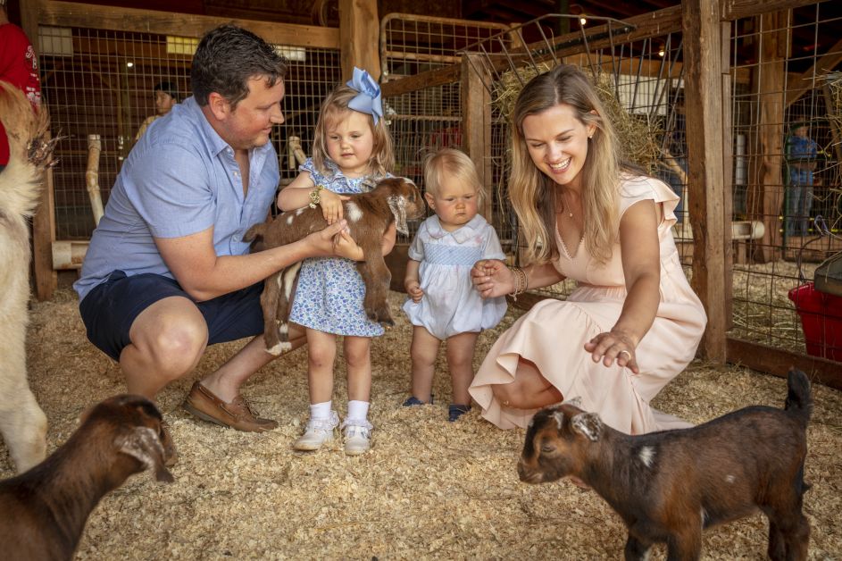 Family playing with goats