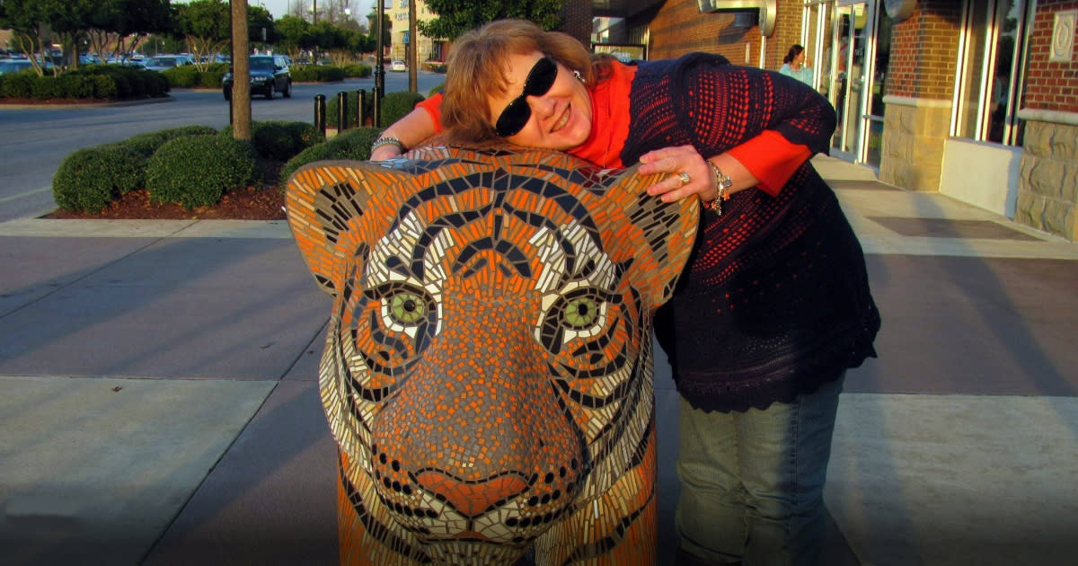 Auburn Tiger Fan hugging the Tiger statue