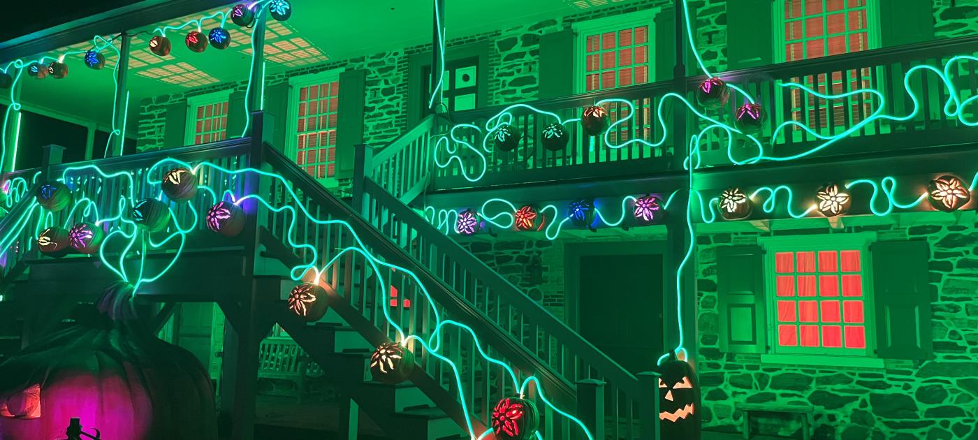 Van Cortlandt Manor lit with green lights during The Great Jack O'Lantern Blaze.