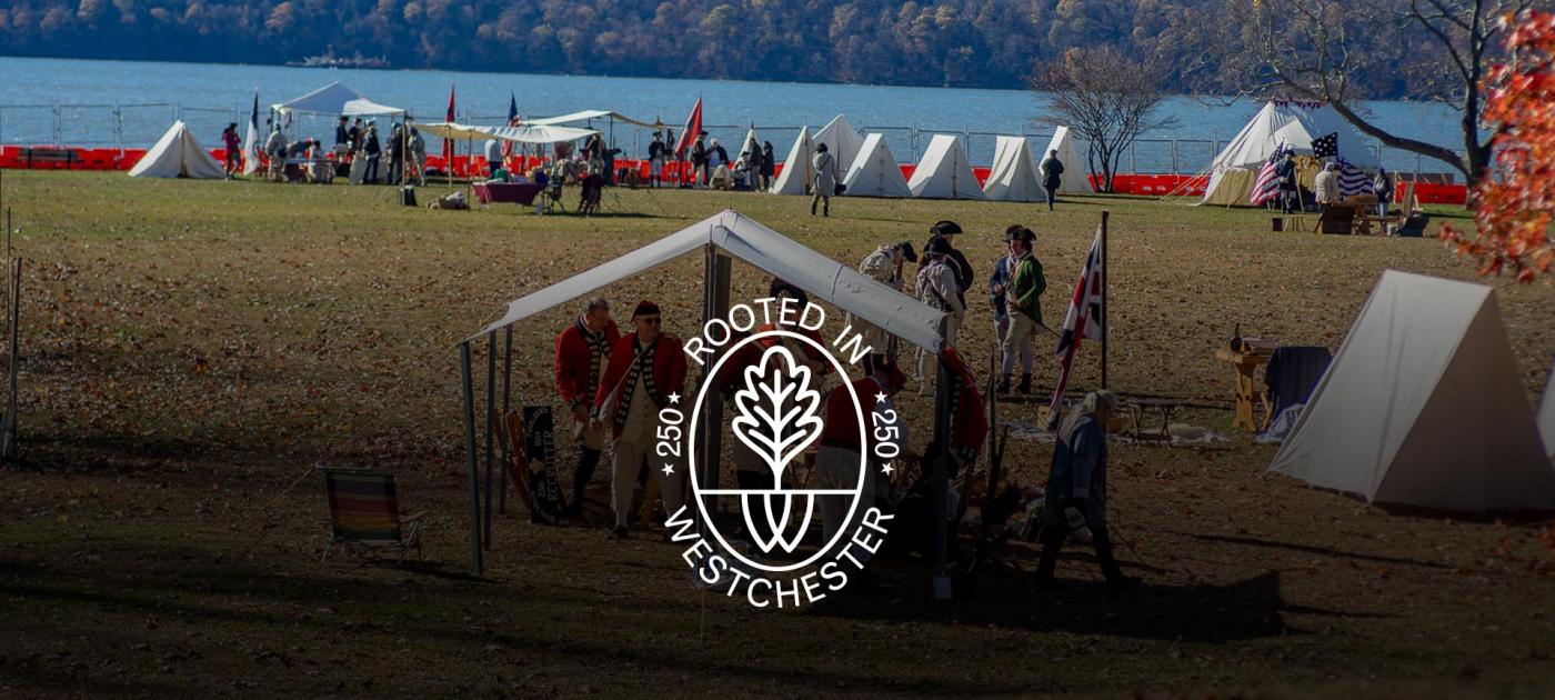 British campsite in foreground and tents along river in background