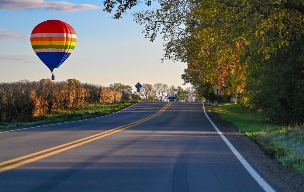 Hot air balloon over a roadway