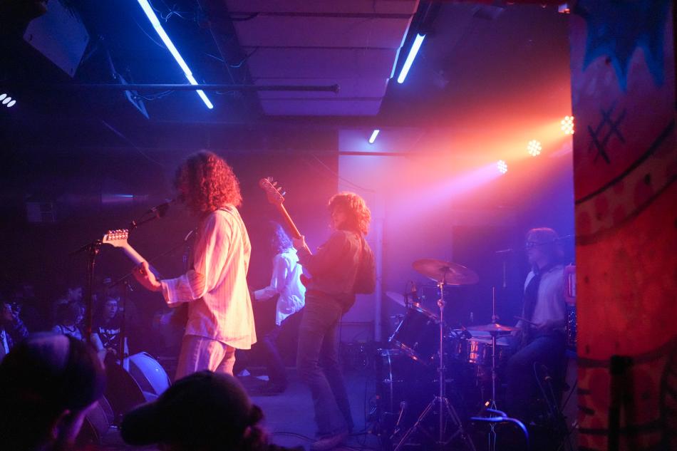 Side view of a band playing at Sound Bar during FoCoMX