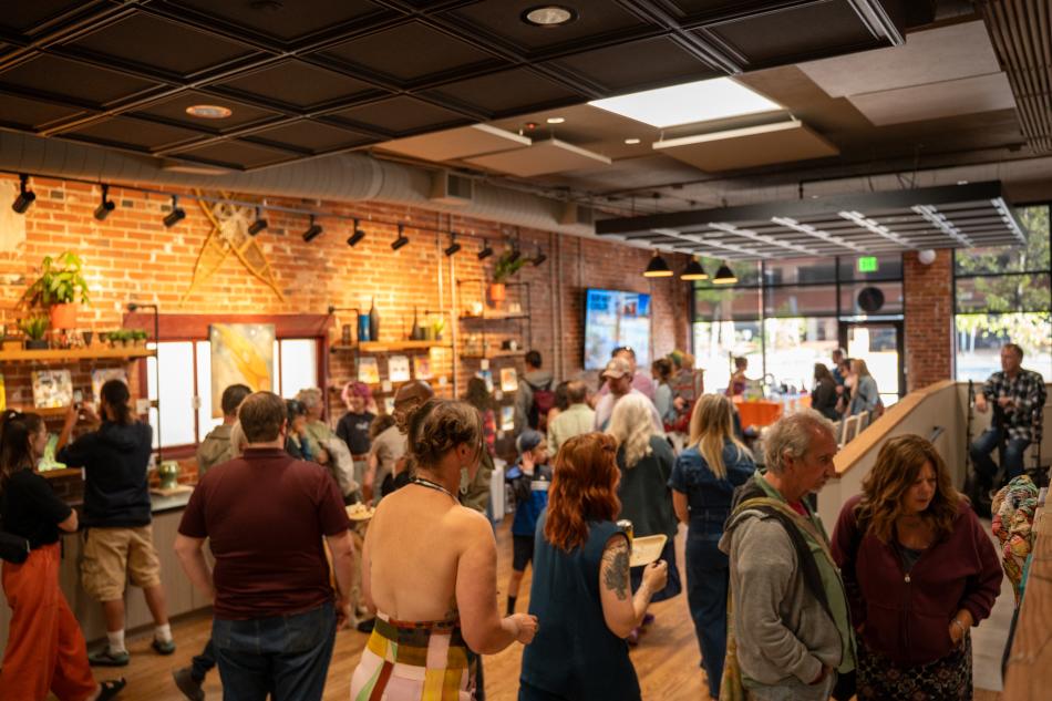 People looking at art in the Fort Collins Welcome Center.