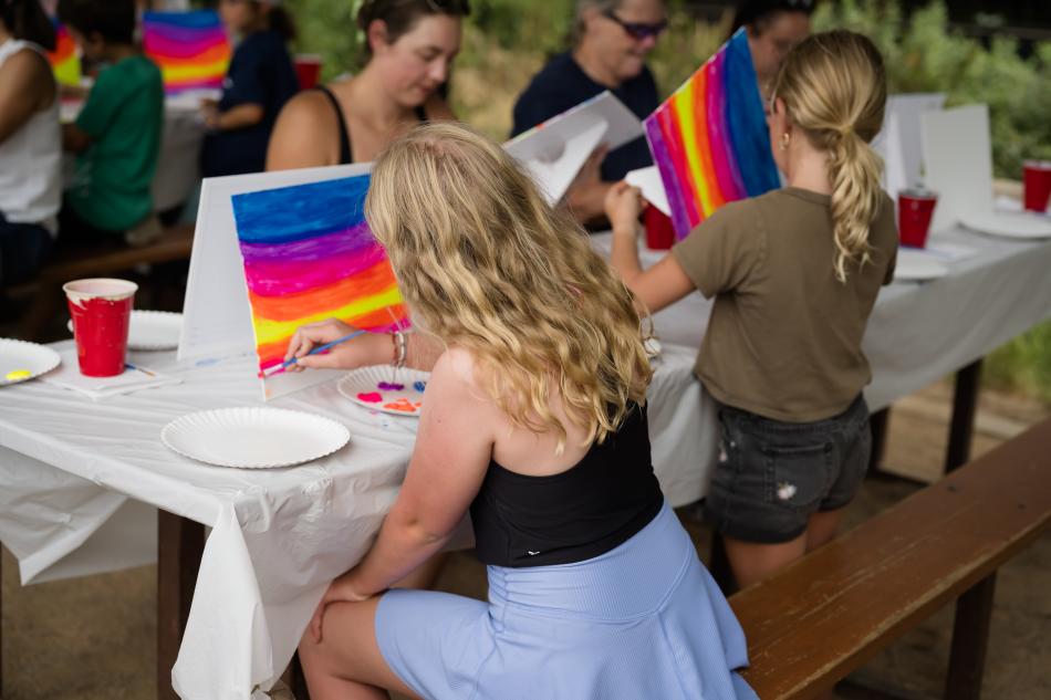 Kids doing a paint activation at Poudre RiverFest