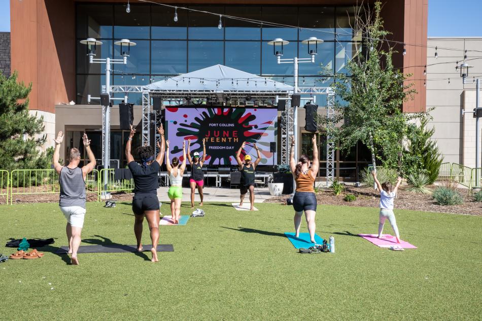 People do yoga at the Juneteenth event at Foothills Mall
