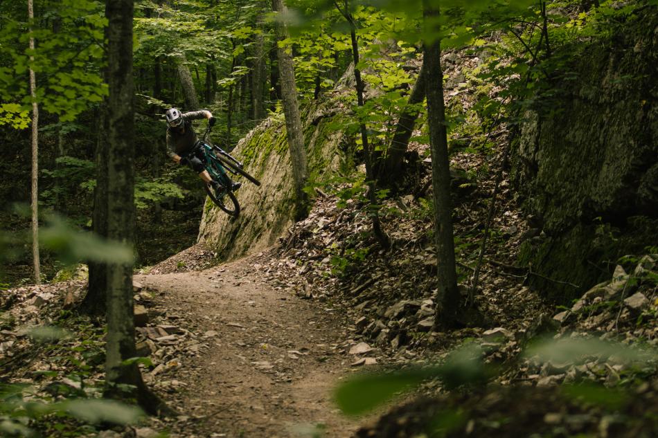 Mountain biker riding on the side of a rock