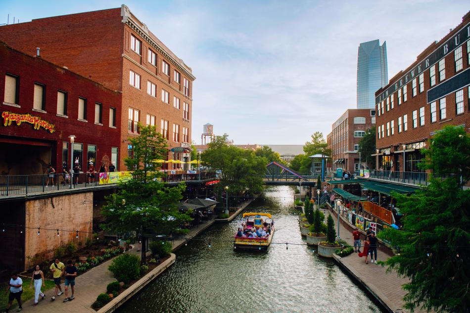 Skyline view of the Bricktown Water Taxi and the canal
