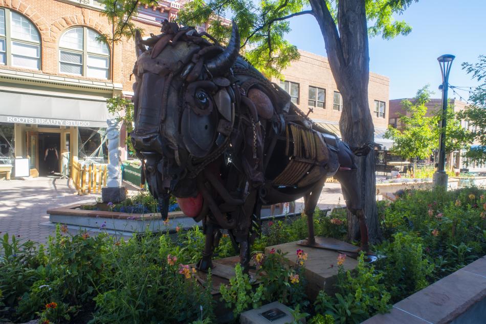 A metal sculpture that looks like a Buffalo.