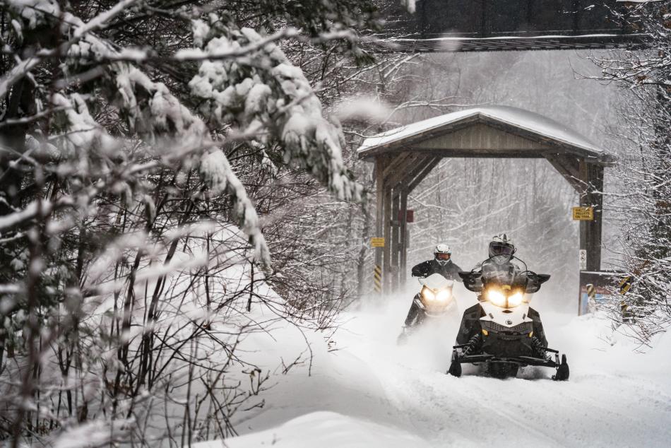 Snowmobilers riding on a section of the Iron Ore Heritage Trail