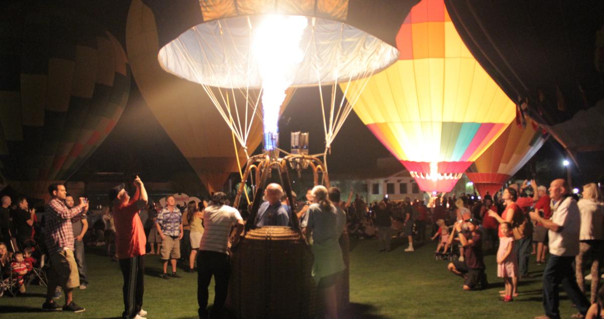 Hot Air Balloons attracting a crowd during the nighttime