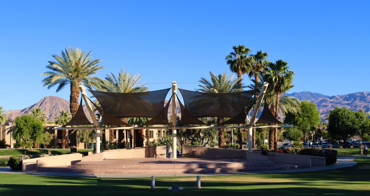 An open amphitheater with sloped event lawn space surrounding it.