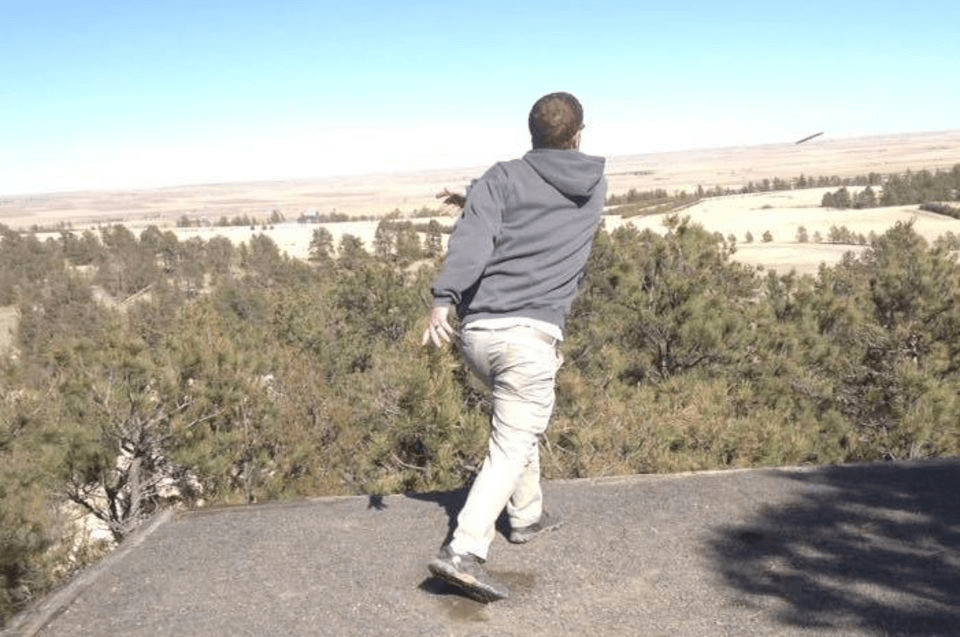 A man playing Disc Golf overlooking a scenic view near Cheyenne, WY.