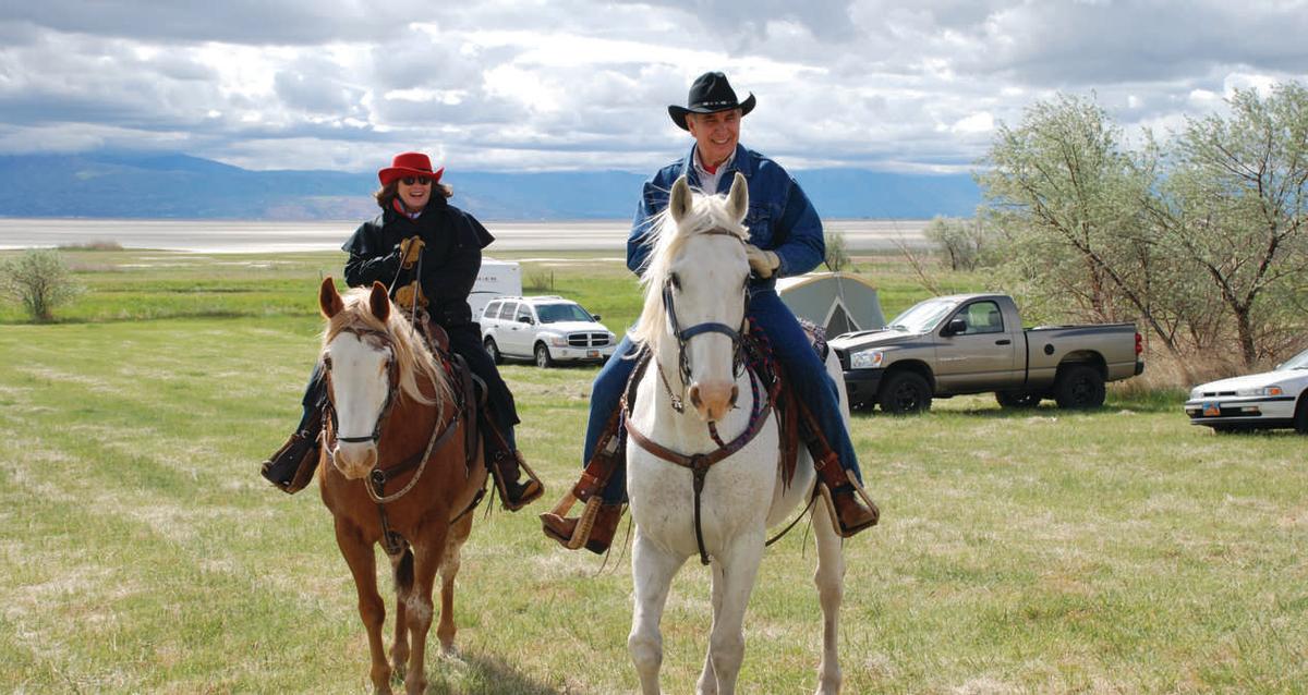 Couple riding on horseback in Utah
