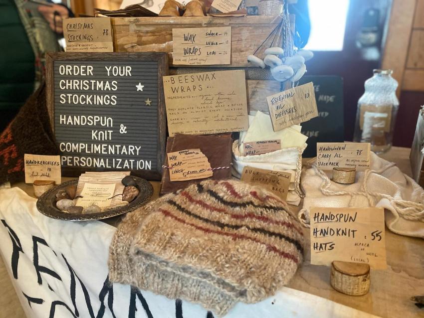 A merchant table featured hand-spun hand-knit hats, bees wax and other artisan offering sat the Holiday Market in downtown Marquette