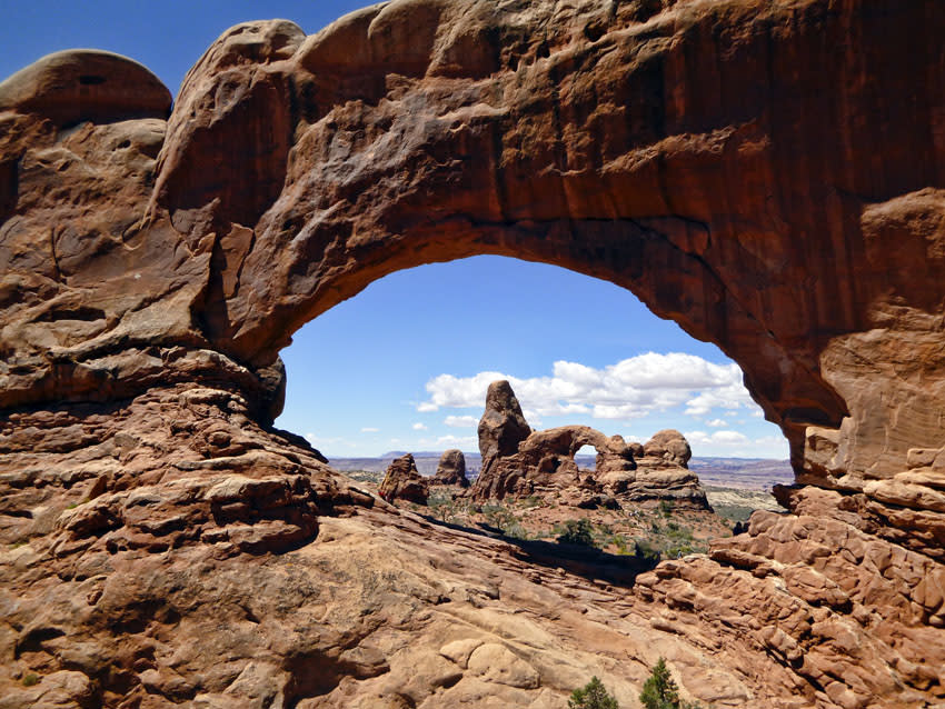 An arch framed by another arch in the foreground at Arches National Park in Utah.