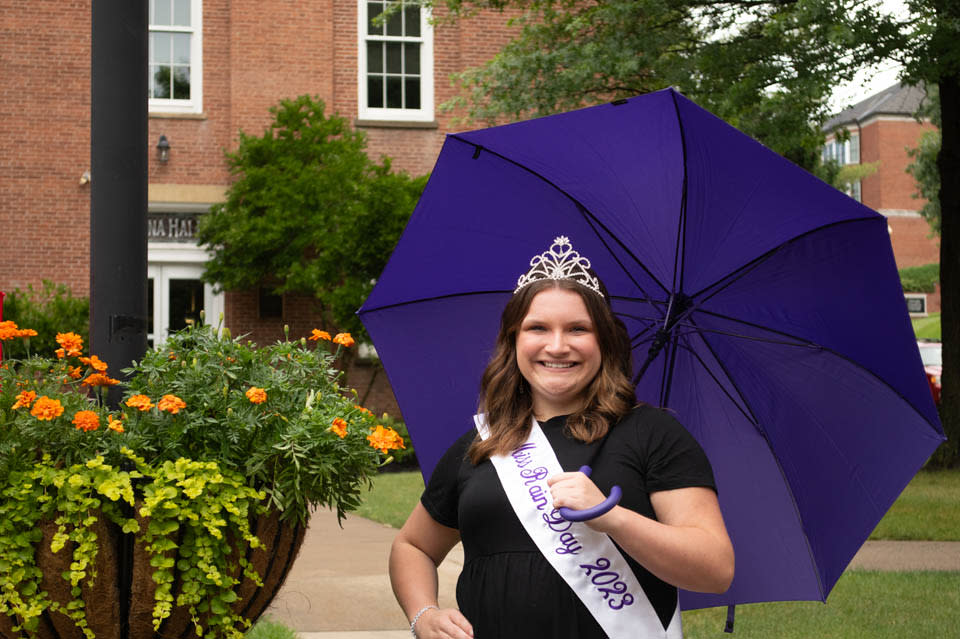lady dressed for pageant holding an umbrella