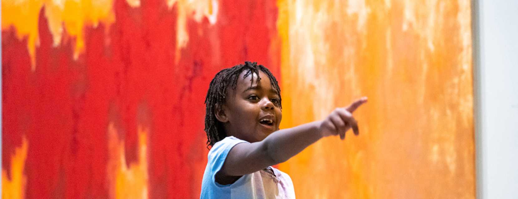 A child pointing at art at the Clyfford Still Museum in Denver, Colorado