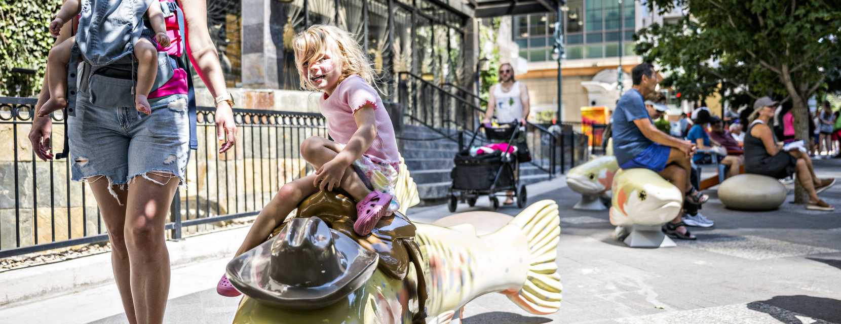 The "Howdy Trouty" cutthroat trout sculpture, representing the state fish, welcomes visitors to take a break and some photos on Denver's 16th Street.