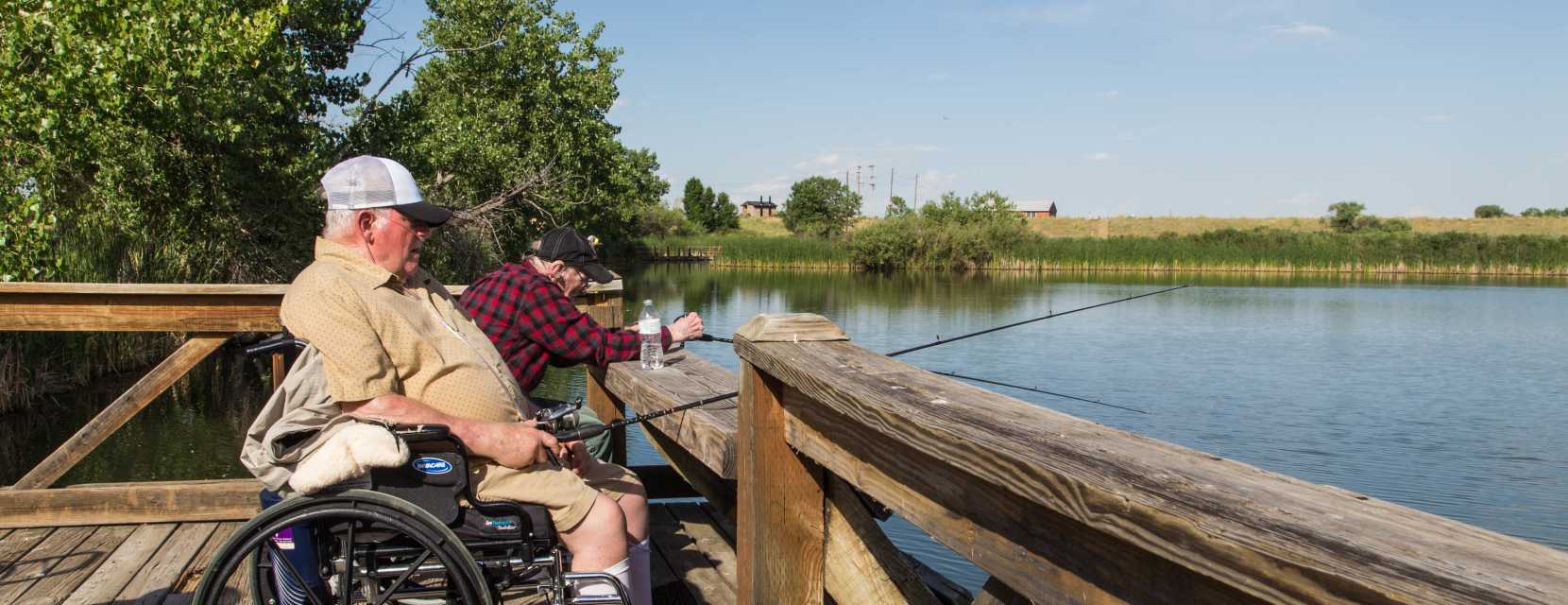 Man in a wheelchair fishing at Rocky Mountain Arsenal National Wildlife Refuge