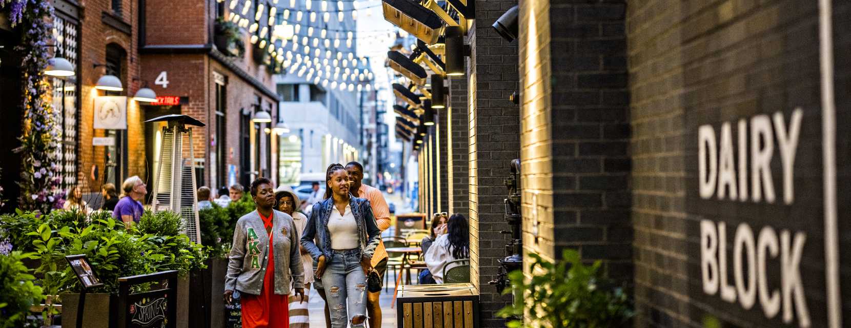 People walking through the Dairy Block alleyway in Denver, Colorado.