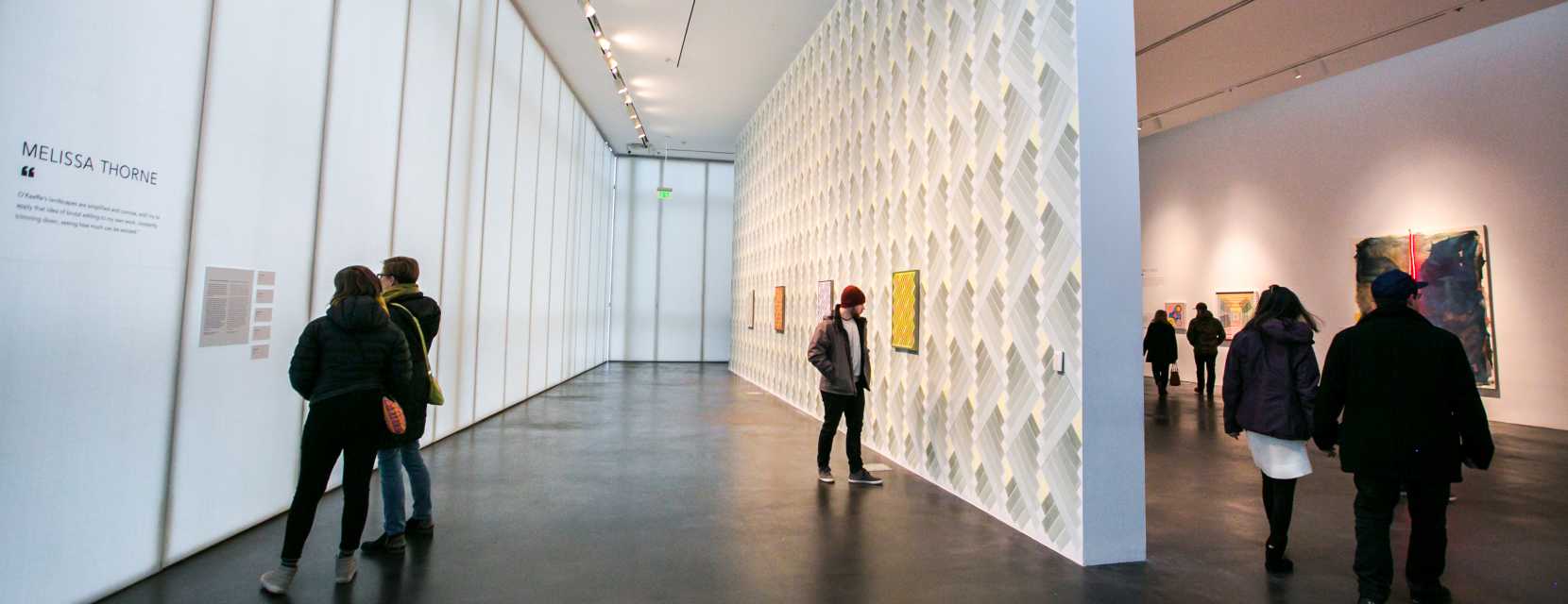 Several people admire the galleries inside MCA Denver.